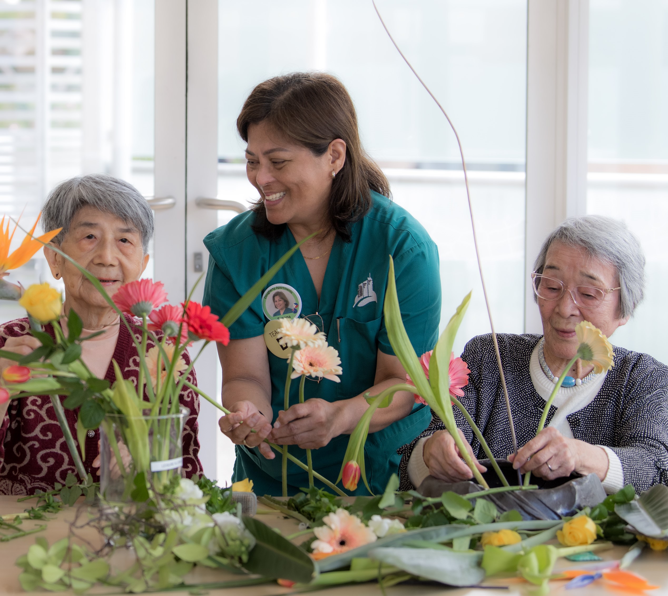 Residents flower arranging together at Dougherty Apartments.