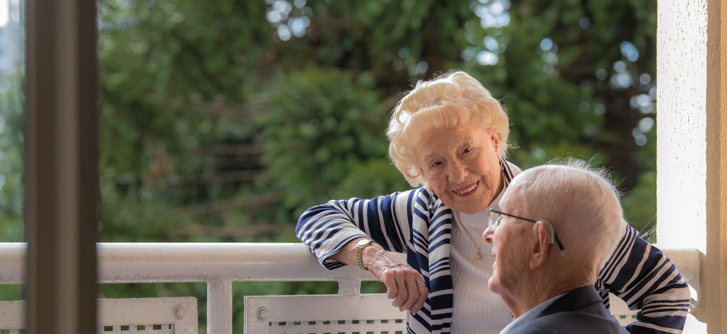 Couple enjoying the balcony view at Dougherty Apartments, Chatswood.