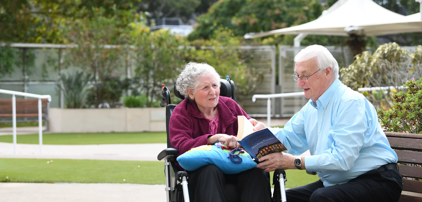 A resident being read to in the Palmer Wing
