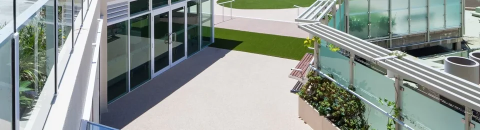 Outdoor courtyard and glass walkway at Dougherty Apartments